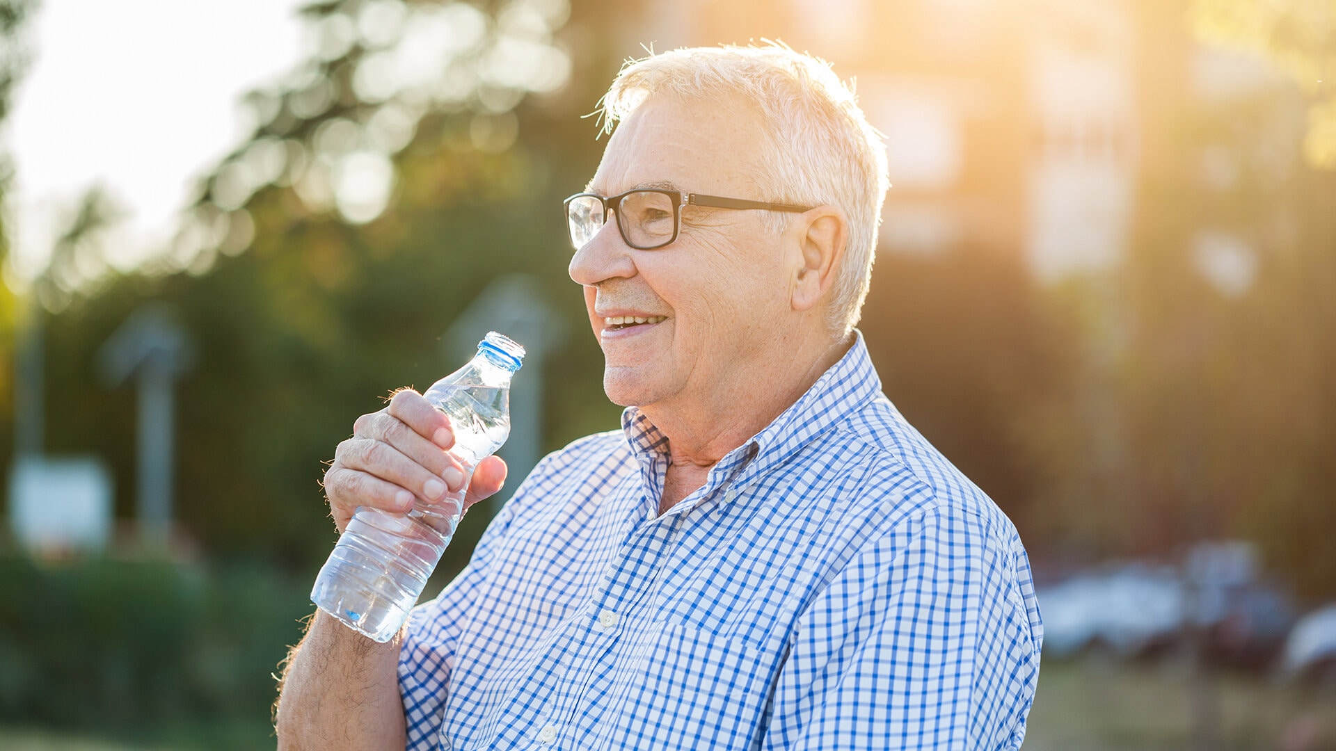 A senior citizen drinking water at Aspen house retirement home